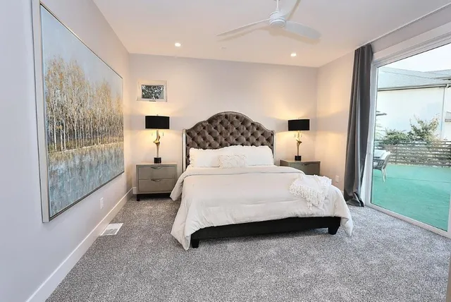 a bathroom with a tub a double vanity sink and a mirror