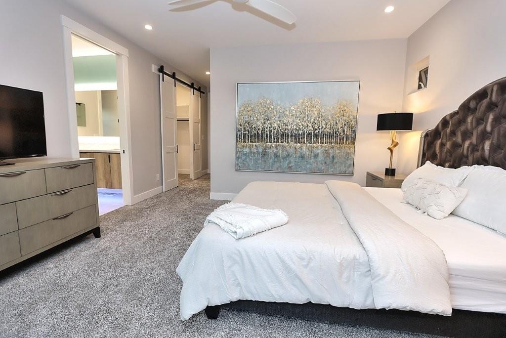 4014 Capitola Hills Court Fair Oaks, CA 95628 - Photo 29 of 59 a bedroom with a bed and large window