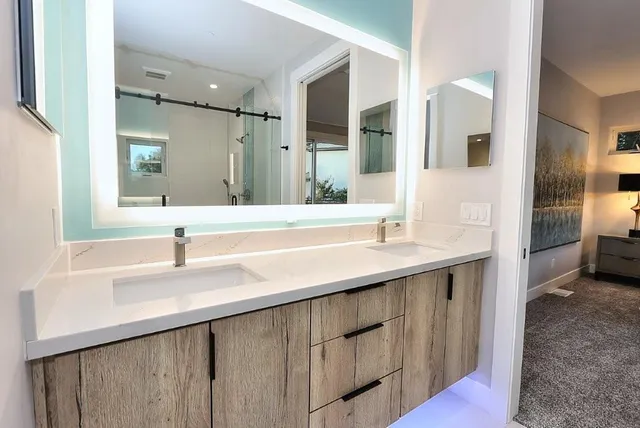 a bathroom with a toilet a sink and mirror