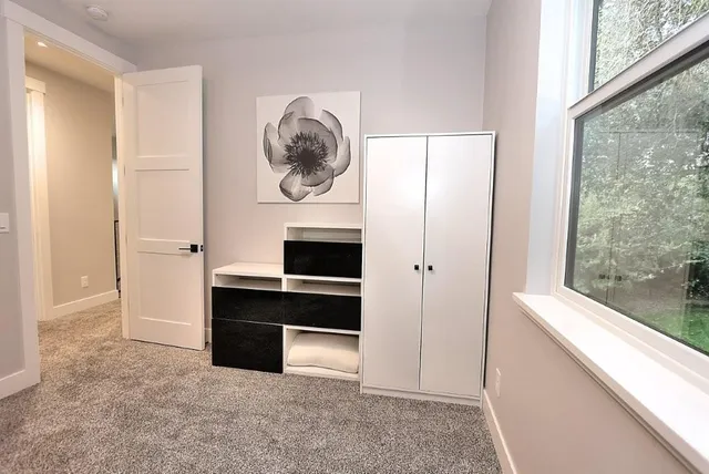 a spacious bedroom with two beds and a window