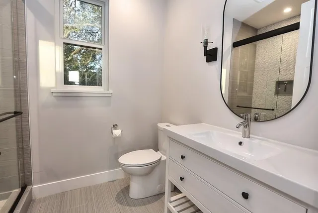 a bedroom with a bed wall painting and a window