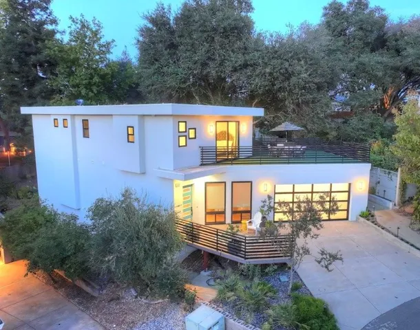 a front view of a house with large windows