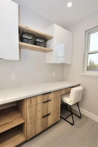 a view of a chairs and table in back yard of the house