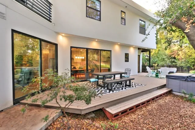 a backyard of a house with table and chairs