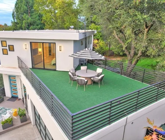 a view of a house with a backyard and sitting area