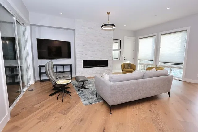 a living room with furniture and a large window