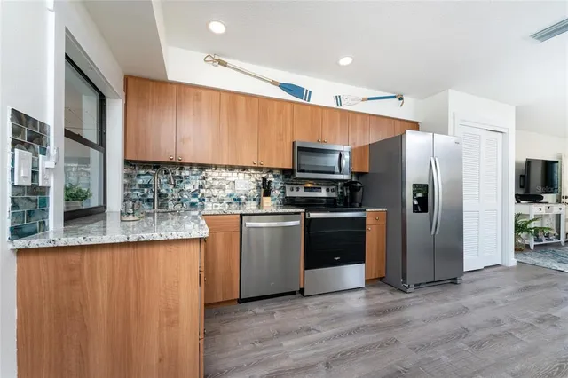 a kitchen with stainless steel appliances a refrigerator and a sink