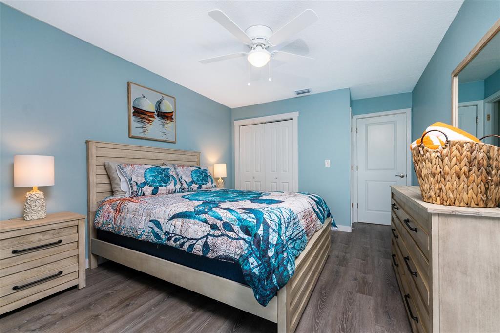 5041 North Beach Road, Unit 1A Englewood, FL 34223 - Photo 10 of 19 a bedroom with a bed and a chandelier