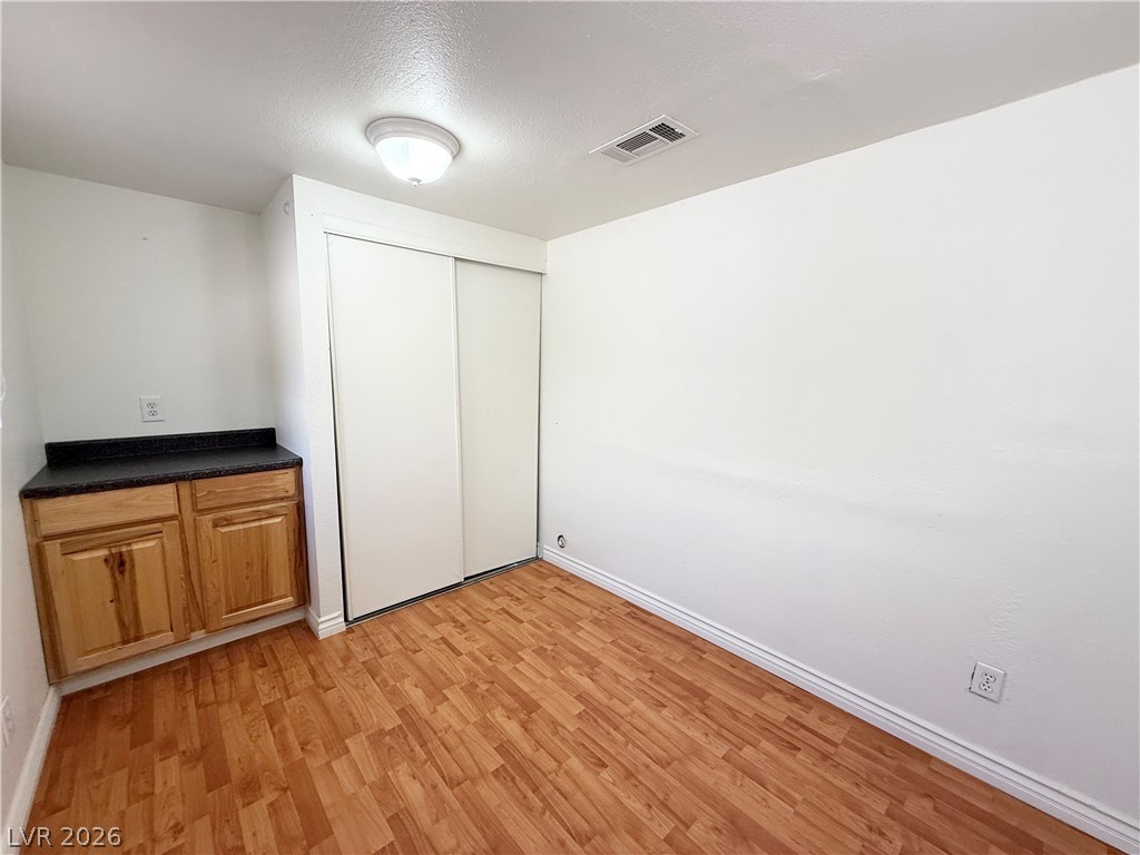 616 Greenway Road Henderson, NV 89002 - Photo 13 of 32 Laminate flooring and built-in cabinetry enhance this practical room.