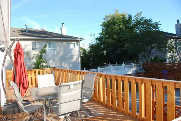 a view of a roof deck with wooden floor and fence