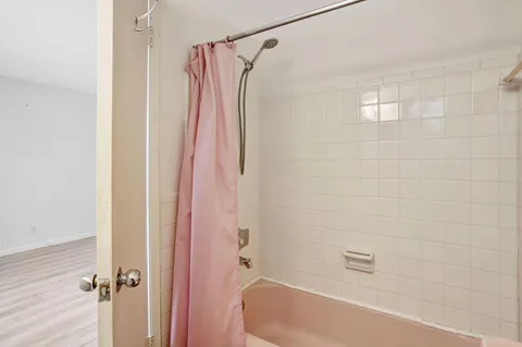 a bathroom with a shower and a bath tub