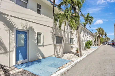 a view of a house with a palm tree