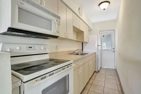a kitchen with stainless steel appliances granite countertop a stove and a microwave