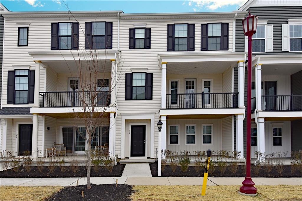 a front view of a residential apartment building with a yard