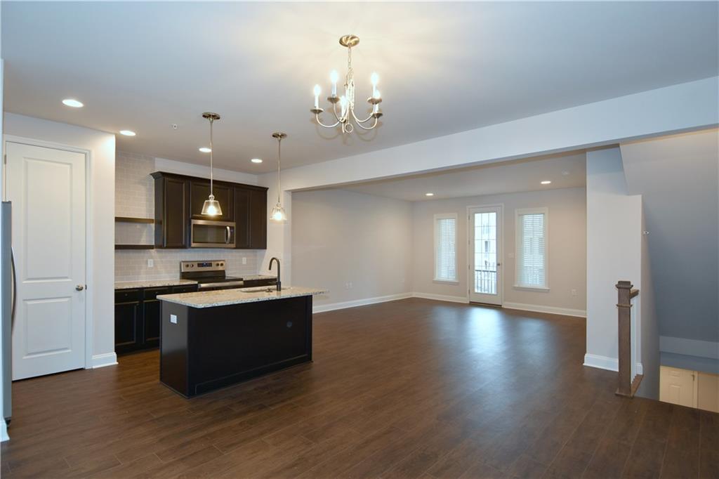 122 Gress Road Cranberry Township, PA 16066 - Photo 17 of 33 a kitchen with stainless steel appliances granite countertop a sink a stove and a wooden floors