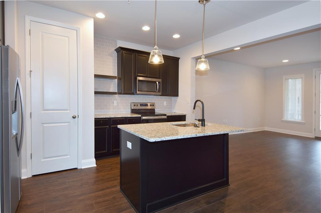 122 Gress Road Cranberry Township, PA 16066 - Photo 19 of 33 a kitchen with a sink cabinets and wooden floor