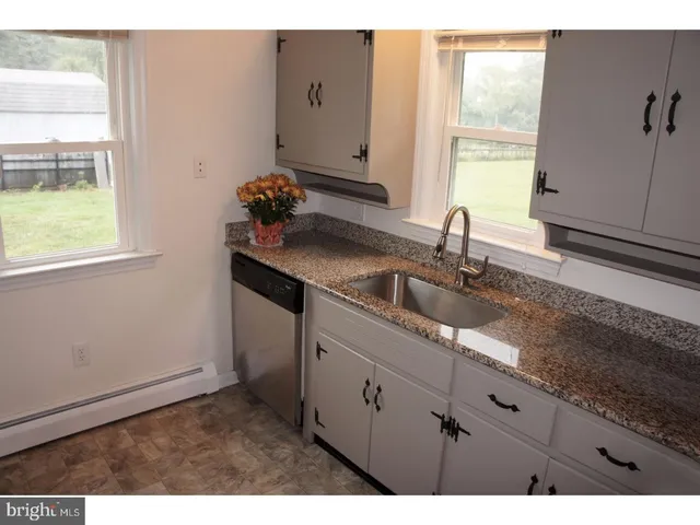 a kitchen with a sink cabinets and window