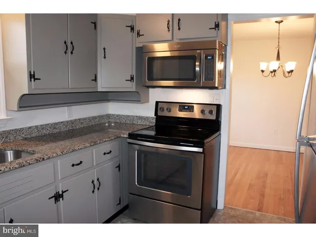 a kitchen with a stove and a microwave
