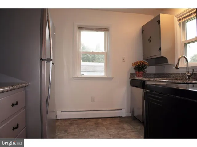 a kitchen with cabinets appliances and a window