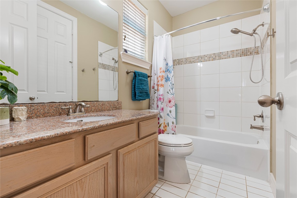 5733 Kansas Street Houston, TX 77007 - Photo 12 of 36 a bathroom with a granite countertop sink a toilet and shower