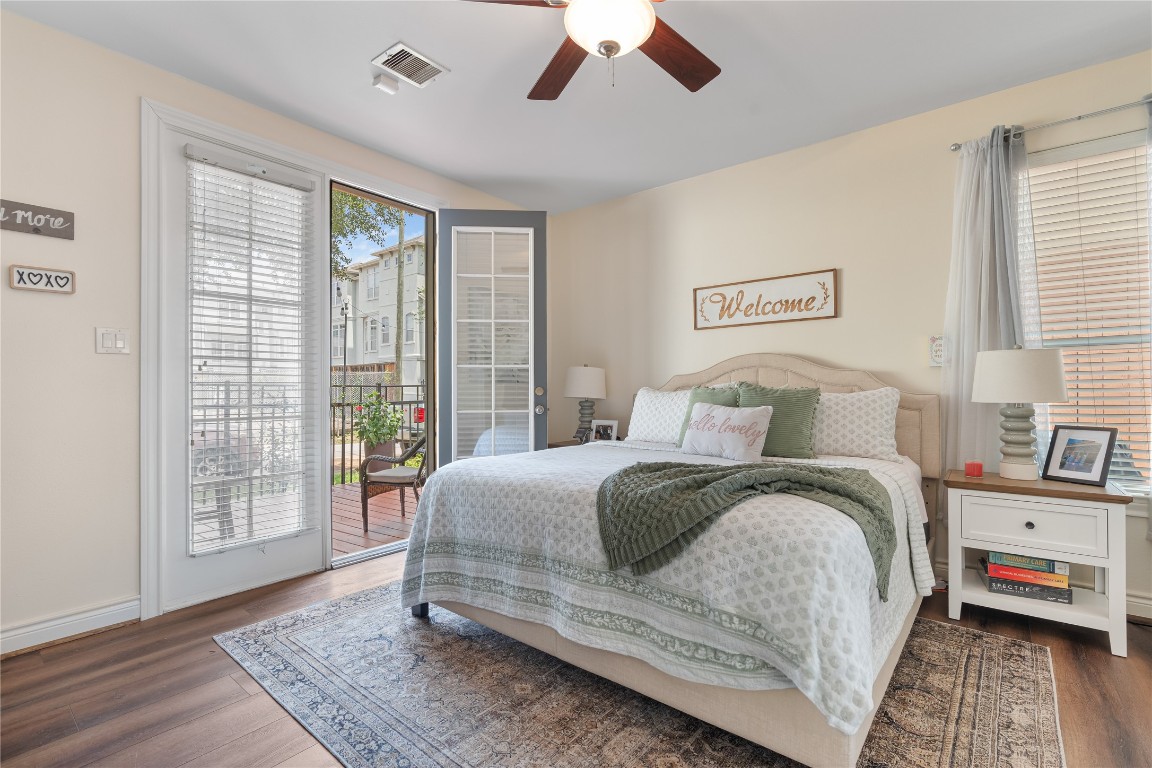 5733 Kansas Street Houston, TX 77007 - Photo 13 of 36 a bedroom with a bed and wooden floor