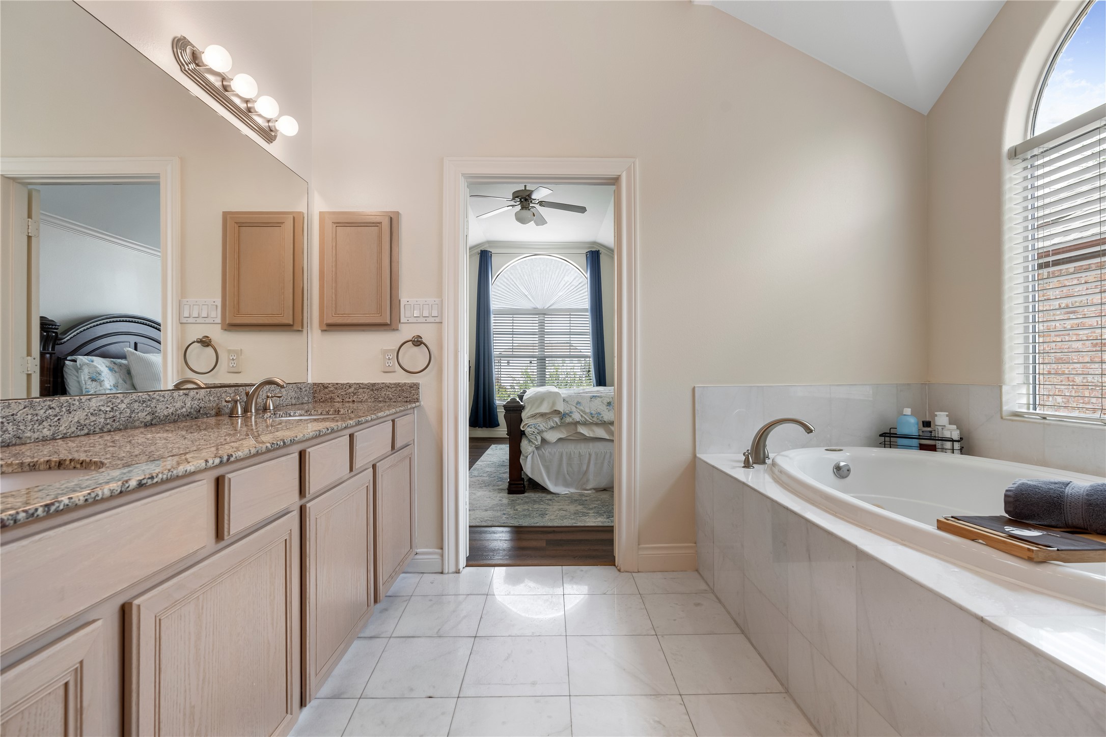 5733 Kansas Street Houston, TX 77007 - Photo 19 of 36 a spacious bathroom with a granite countertop tub sink and mirror