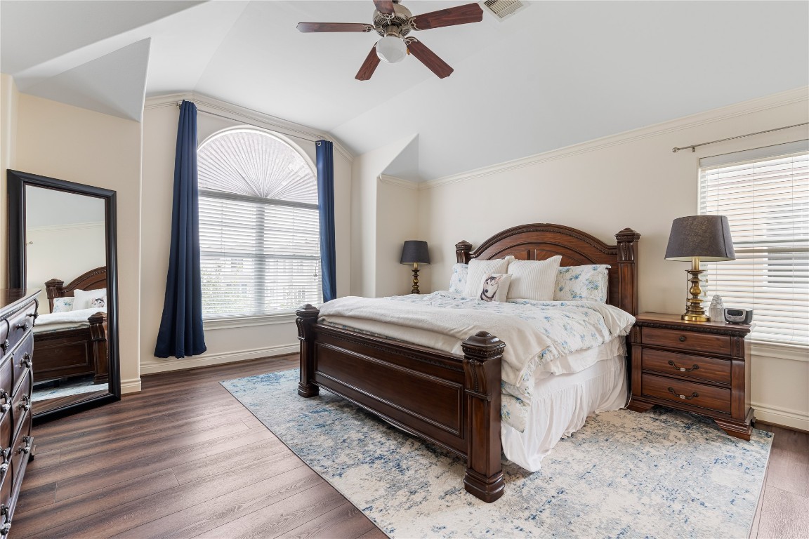 5733 Kansas Street Houston, TX 77007 - Photo 22 of 36 a bedroom with a bed next to a window with a flat screen tv