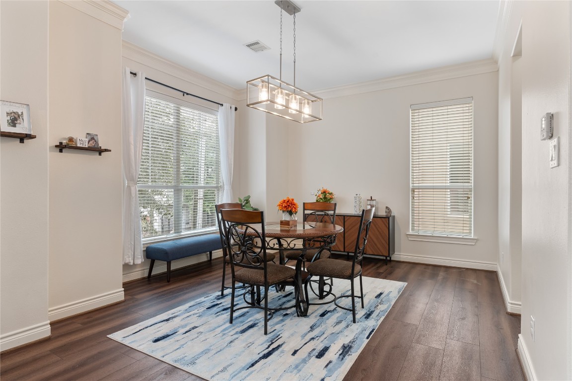 5733 Kansas Street Houston, TX 77007 - Photo 26 of 36 a view of a dining room with furniture window and wooden floor