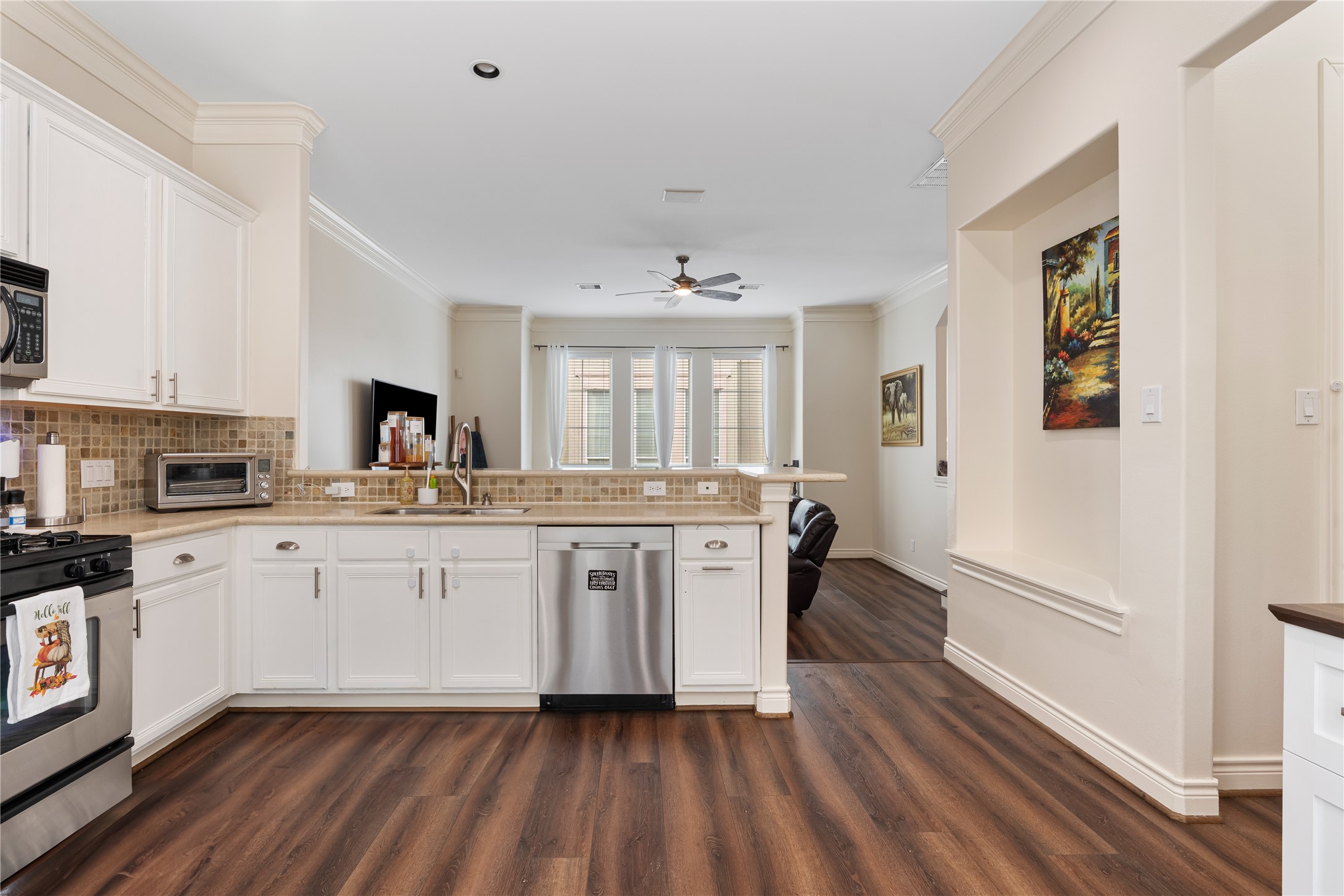 5733 Kansas Street Houston, TX 77007 - Photo 27 of 36 a kitchen with a sink cabinets and wooden floor