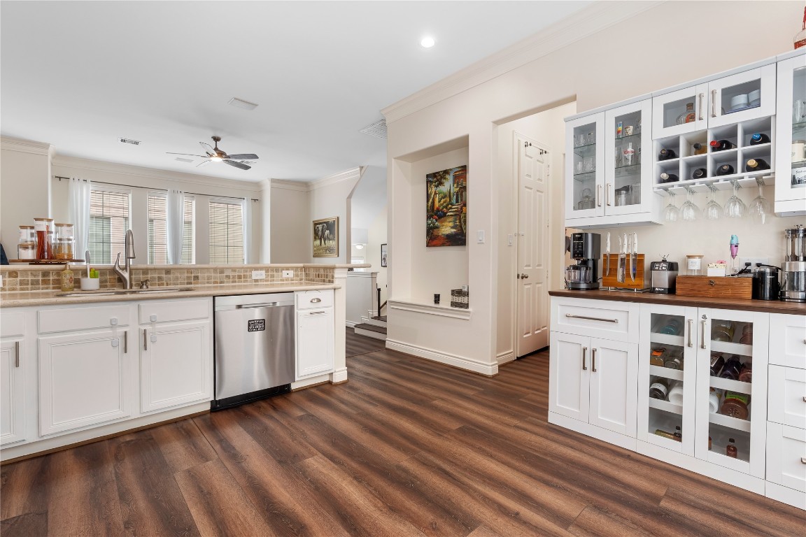 5733 Kansas Street Houston, TX 77007 - Photo 29 of 36 a kitchen with stainless steel appliances cabinets and wooden floor