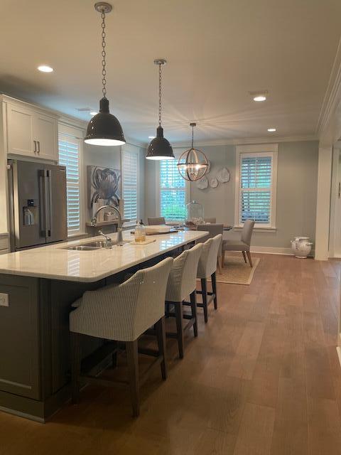 103 Jack Knife Drive Watersound, FL 32461 - Photo 16 of 24 a open kitchen with stainless steel appliances granite countertop a stove a sink a dining table and chairs