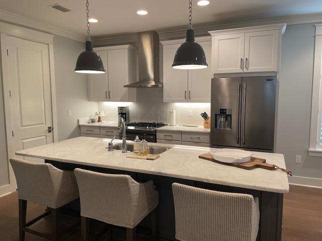 103 Jack Knife Drive Watersound, FL 32461 - Photo 18 of 24 a kitchen with stainless steel appliances granite countertop a sink a stove a refrigerator and island