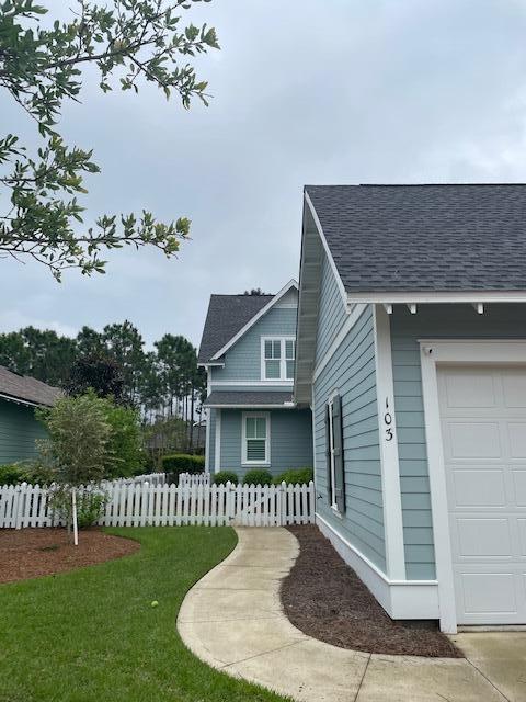 103 Jack Knife Drive Watersound, FL 32461 - Photo 3 of 24 a front view of a house with garden