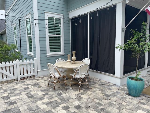 103 Jack Knife Drive Watersound, FL 32461 - Photo 7 of 24 a view of a dinning table and chair in back yard of the house