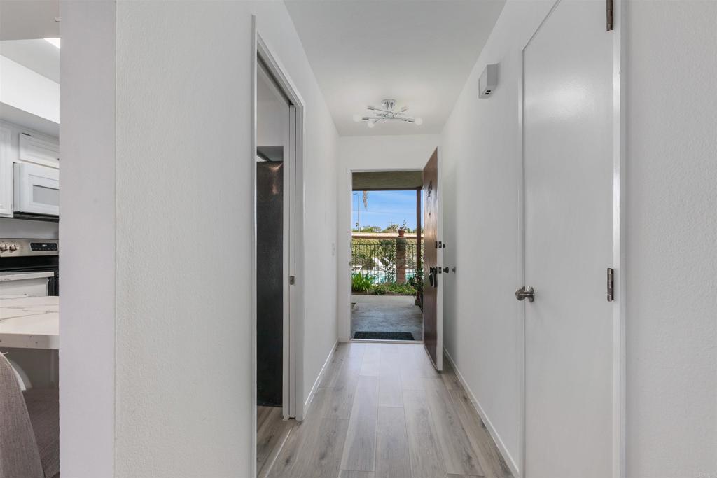 2475 Jefferson Street Carlsbad, CA 92008 - Photo 12 of 14 a view of a hallway with wooden floor and a bathroom