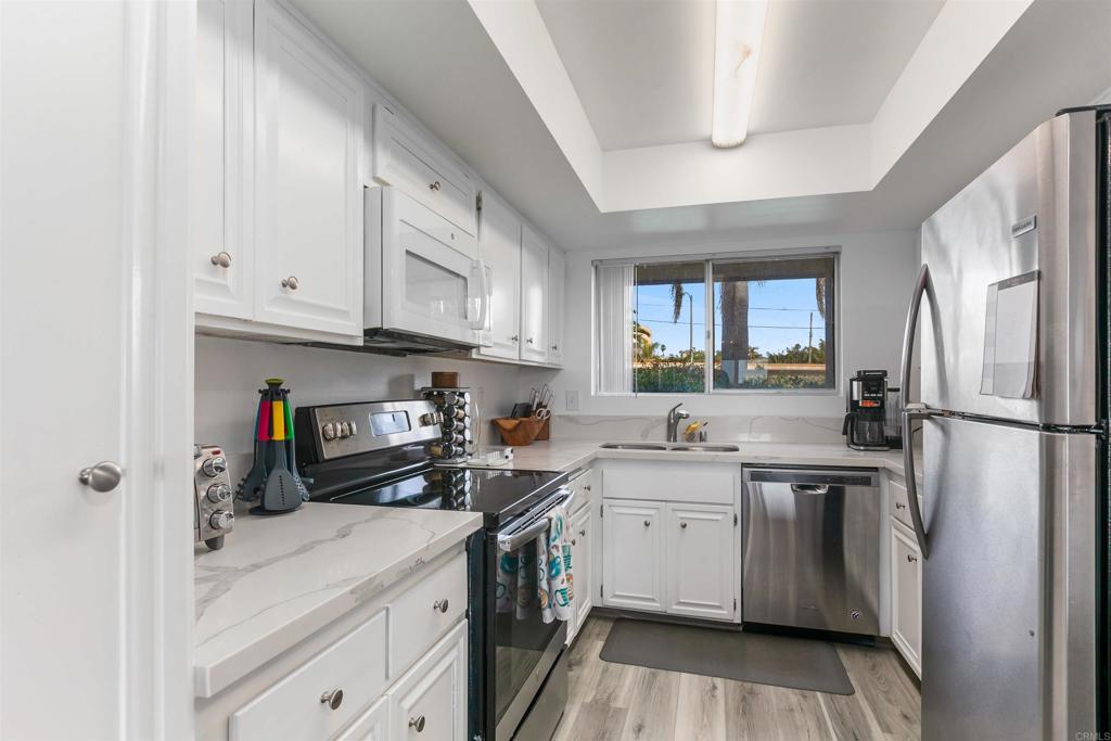 2475 Jefferson Street Carlsbad, CA 92008 - Photo 13 of 14 a kitchen with stainless steel appliances a stove refrigerator sink and cabinets