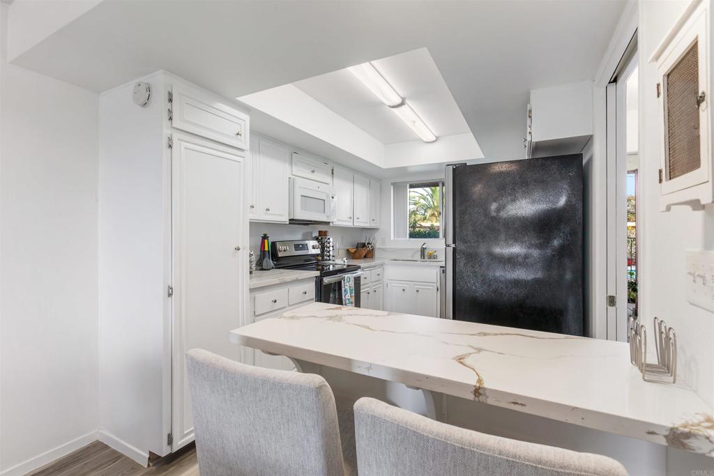 2475 Jefferson Street Carlsbad, CA 92008 - Photo 2 of 14 a kitchen with stainless steel appliances kitchen island granite countertop a refrigerator and a sink