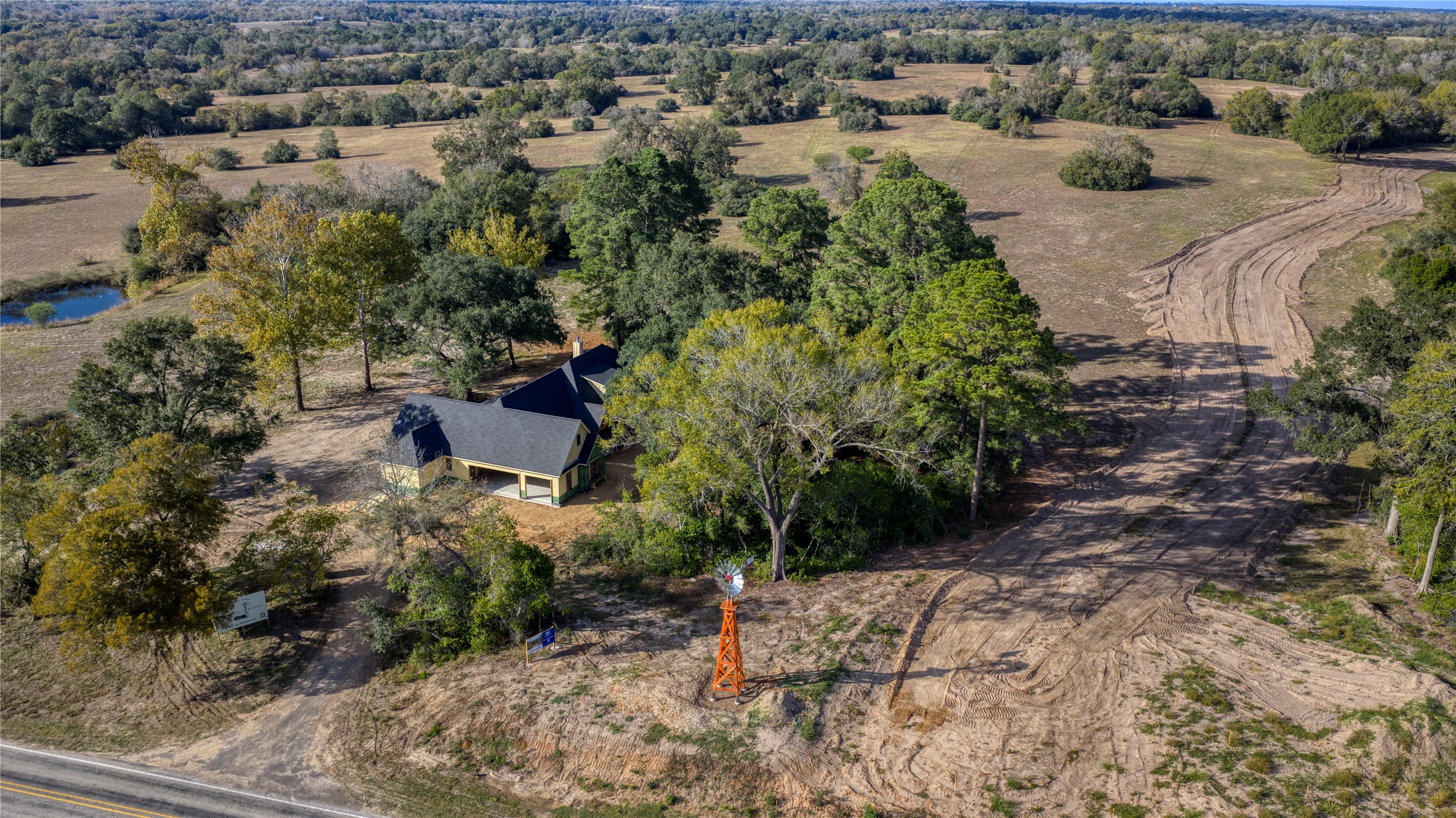 an aerial view of a house with a yard