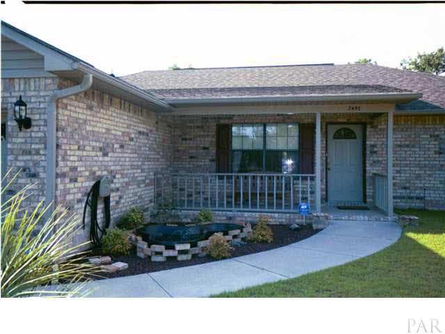 7456 Johnson Road Milton, FL 32583 - Photo 3 of 16 LANDSCAPE FISH POND AT ENTRANCE