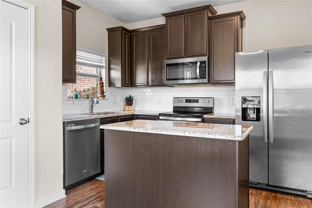 3005 Parker Road Anna, TX 75409 - Photo 3 of 17 Contemporary kitchen featuring wood-finish cabinetry, light-toned countertops, and a white subway tile backsplash