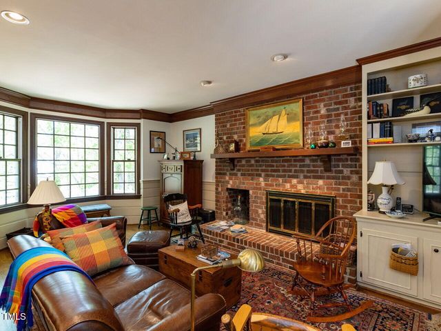 a living room with furniture fireplace and flat screen tv