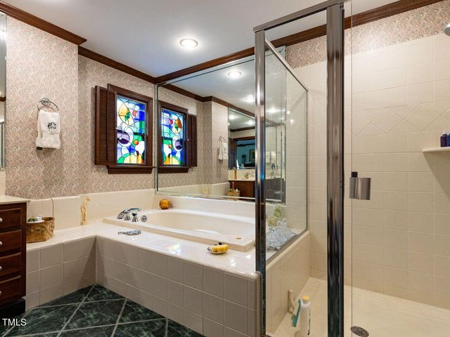 a bathroom with a bathtub a sink and a mirror