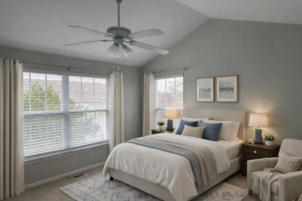 a bedroom with a large bed and a chandelier