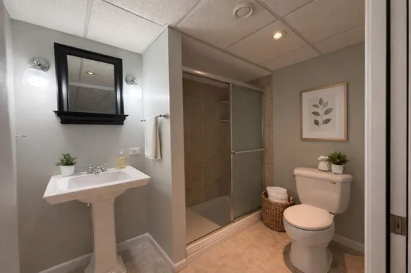 a bathroom with a toilet sink and mirror