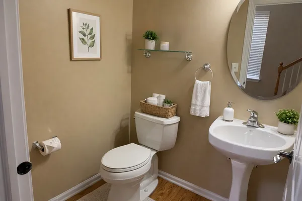a bathroom with a sink mirror and toilet