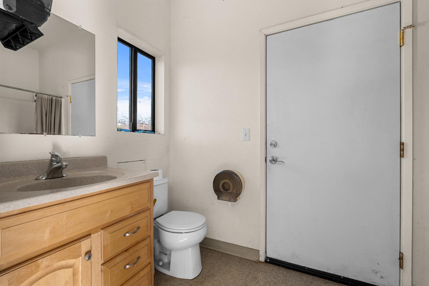 2635 Cleese Road Camino, CA 95709 - Photo 21 of 33 a bathroom with a granite countertop toilet sink and mirror