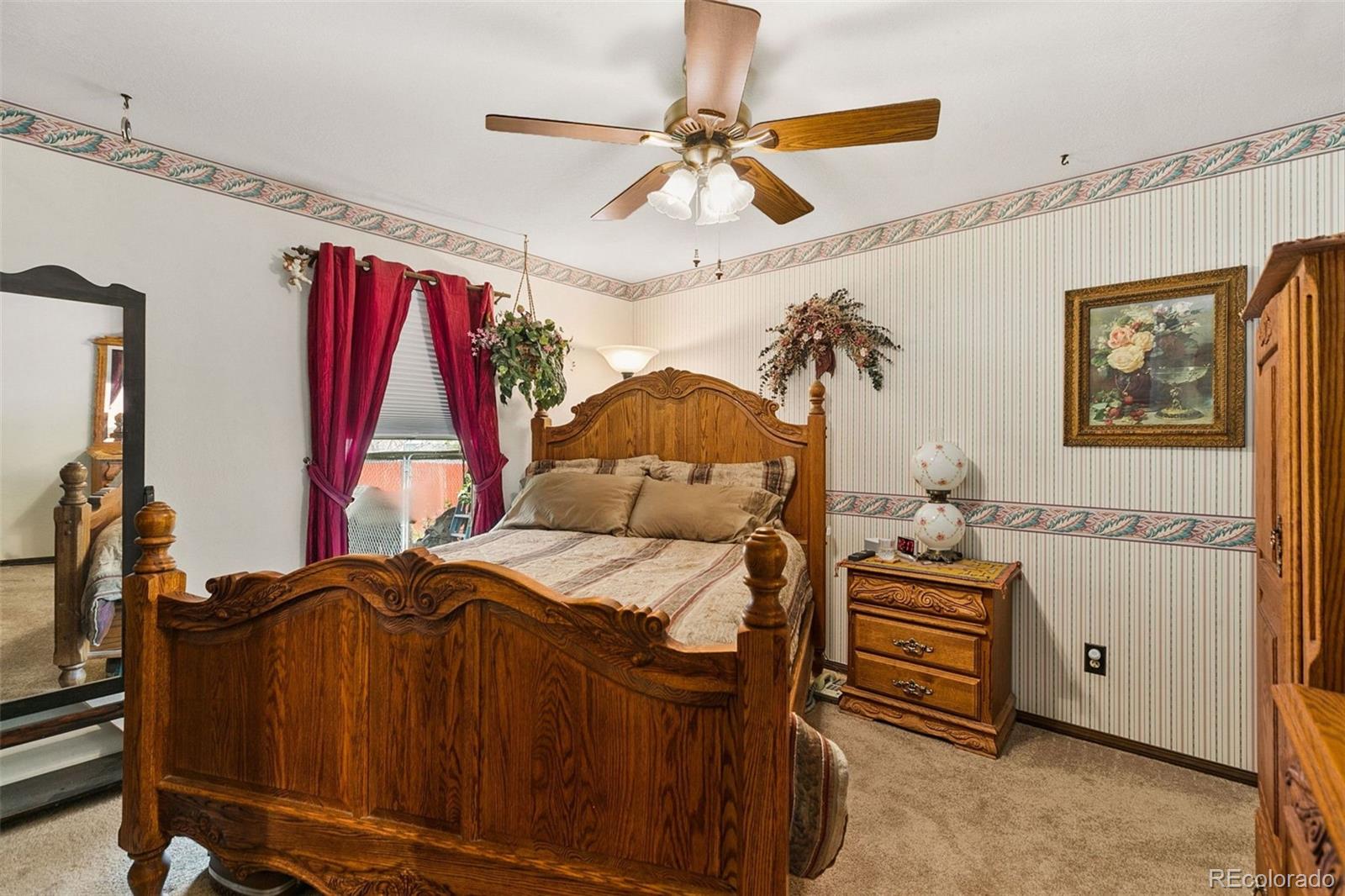 13 Maple Drive Frederick, CO 80530 - Photo 15 of 32 a bedroom with a bed and a ceiling fan