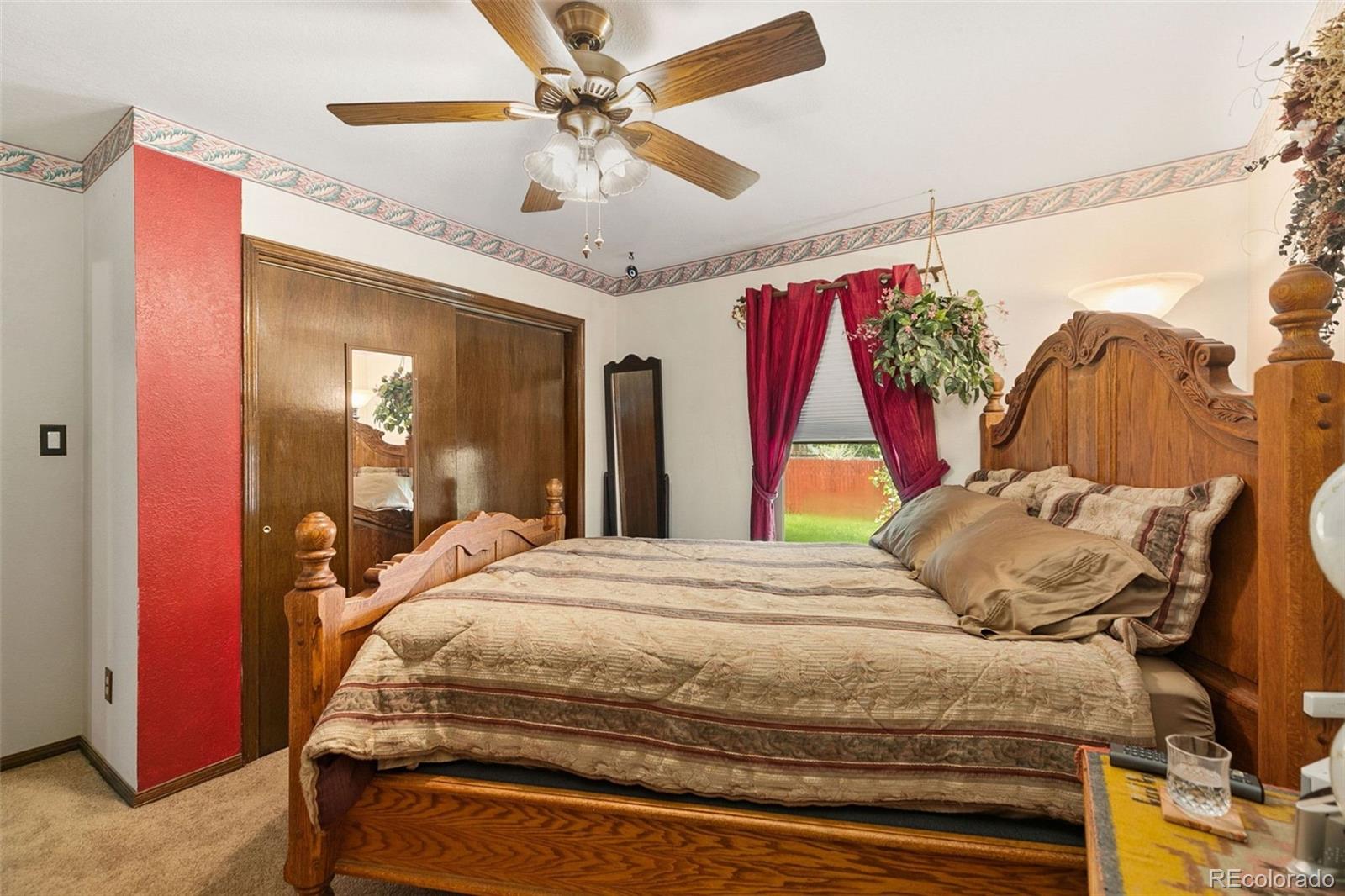 13 Maple Drive Frederick, CO 80530 - Photo 16 of 32 a bedroom with a bed and a mirror