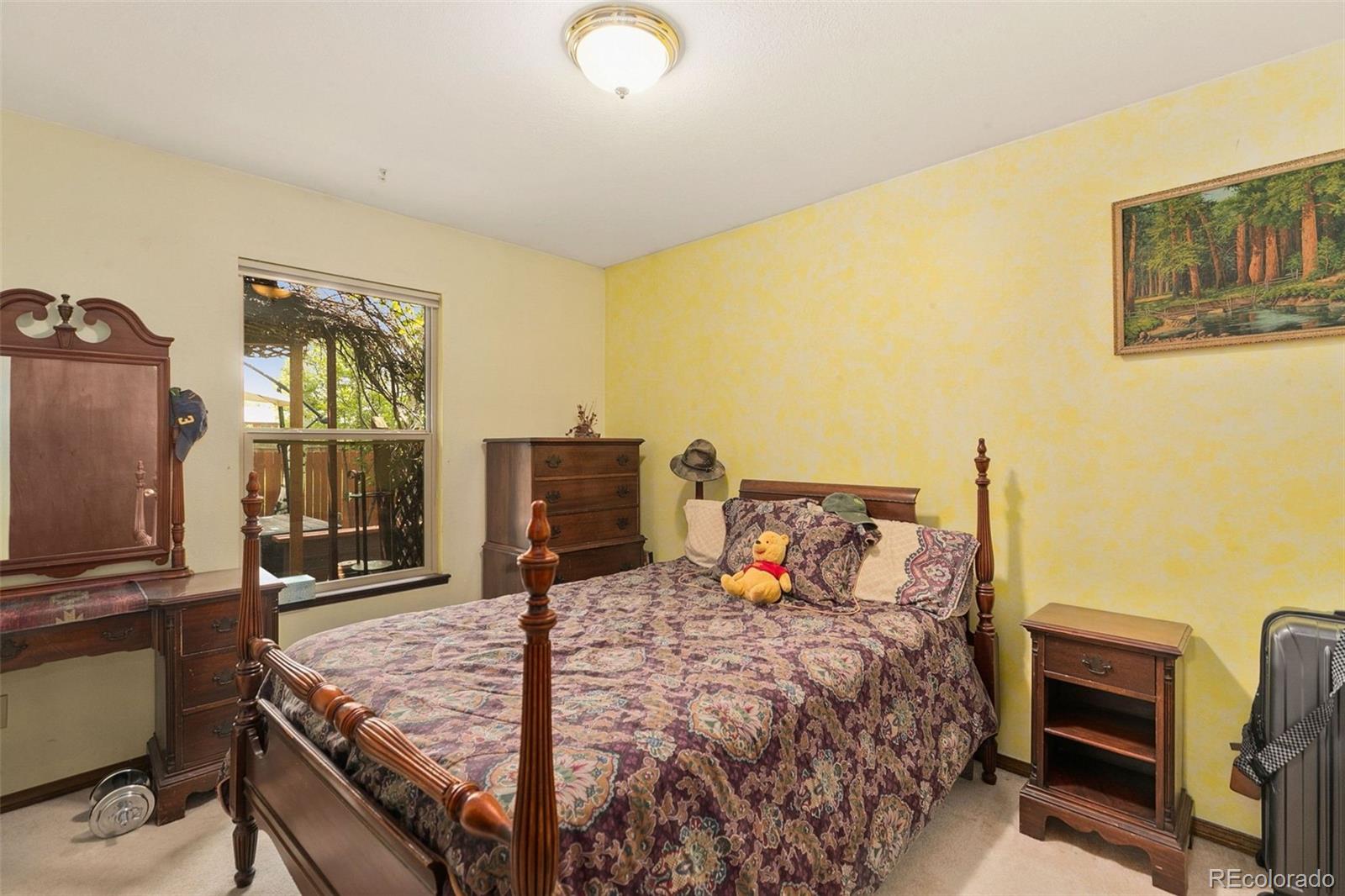 13 Maple Drive Frederick, CO 80530 - Photo 18 of 32 a bedroom with a bed and wooden floor