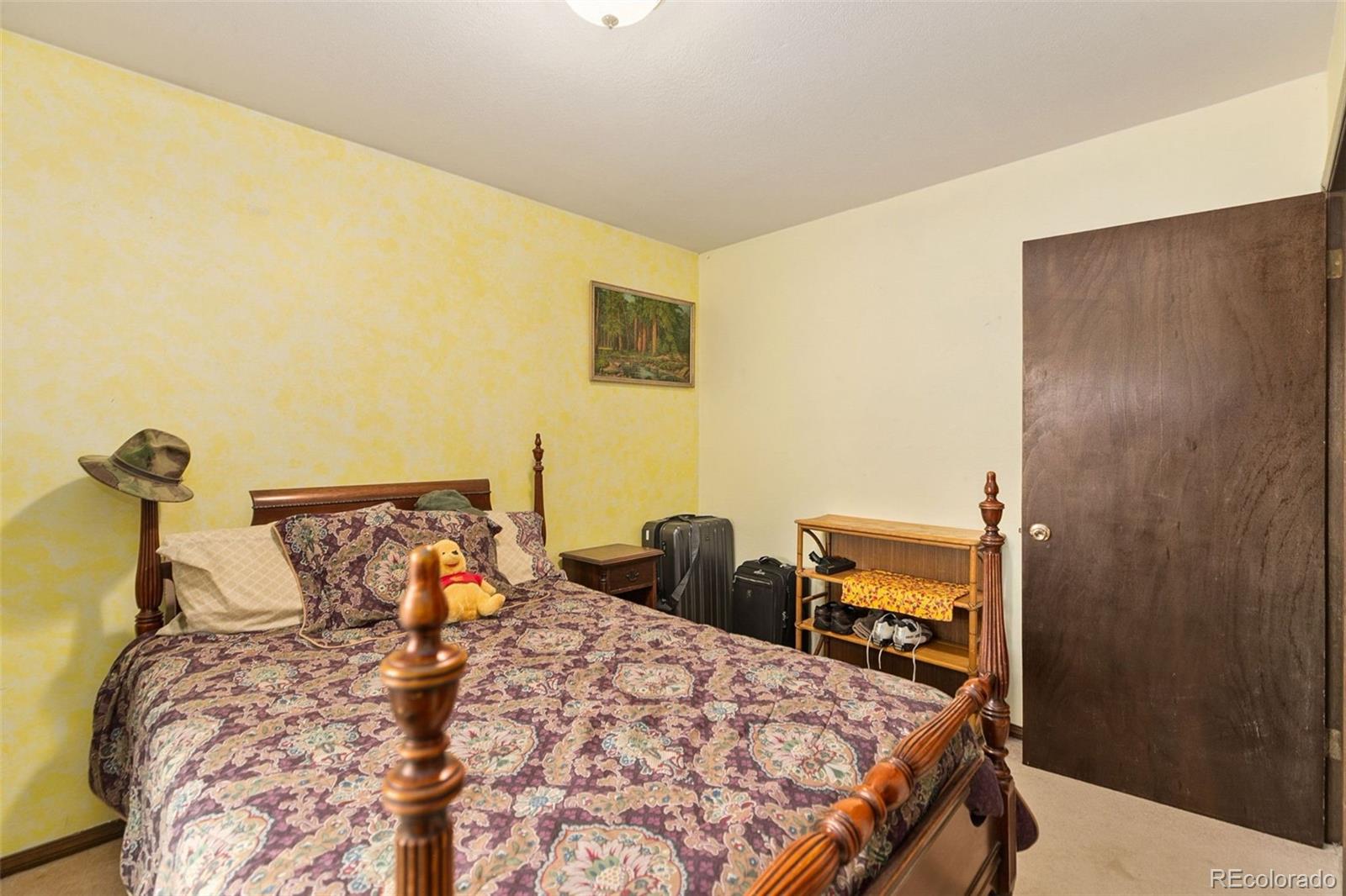 13 Maple Drive Frederick, CO 80530 - Photo 19 of 32 a bed sitting in a bedroom next to a window and a lamp